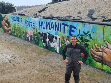 Guillaume Divanach devant la fresque qui recouvre les tags des activistes.