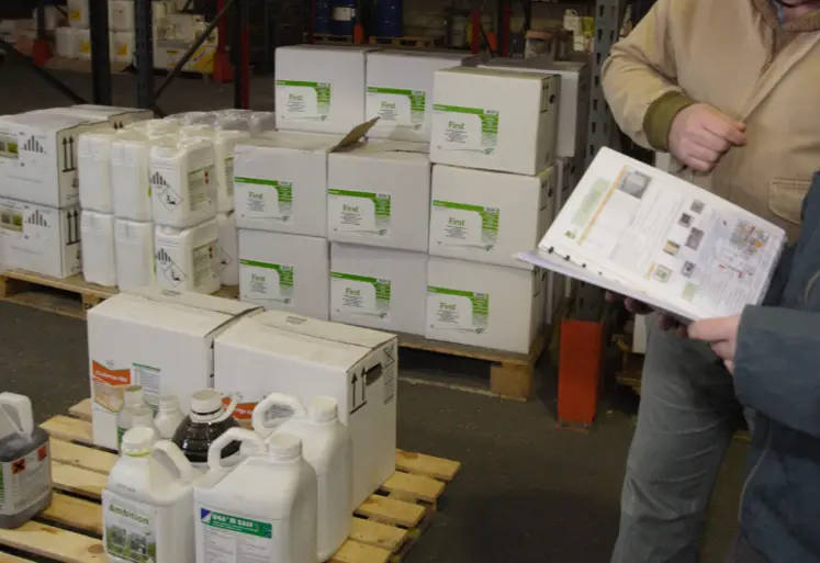 Exploitant agricole et distributeur échangeant prenant livraison d’une commande de produits phytosanitaires. 