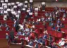 Députés LFI brandissant des pancartes à l'assemblée nationale