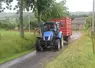 tracteur avec une remorque circulant sur un chemin de campagne 