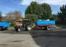 Tracteur avec une benne dans la cour d'une coopérative.