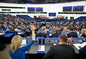 Députés européens vus de dos et levant la main pour voter lors d'une session du Parlement européen