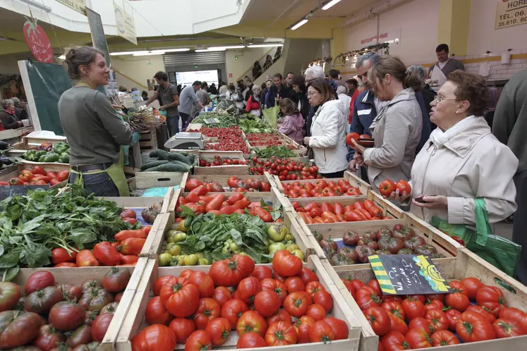 marché local : étal de légumes avec vendeur et clients