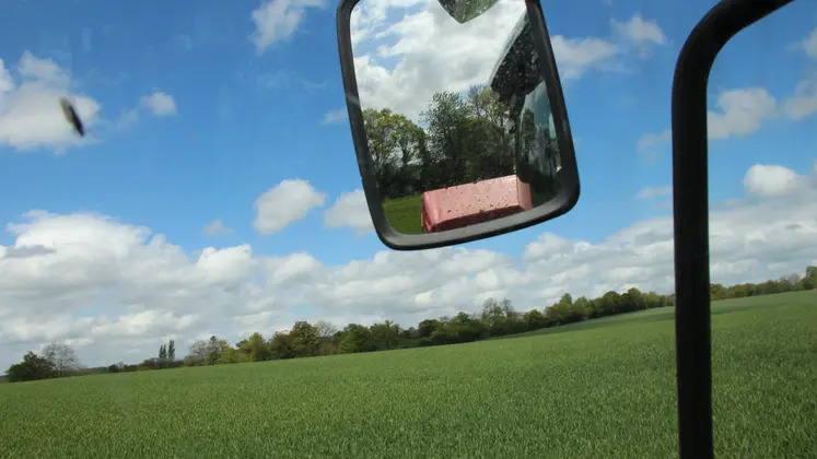 Image d'un champ depuis un tracteur lors d'un apport d'azote sur du blé.