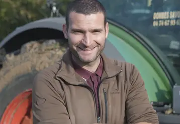   Benoît Merlo, polyculteur-éleveur bio, devant son tracteur.