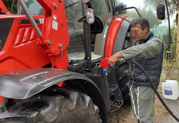 Agriculteur remplissant de GNR le réservoir de son tracteur  